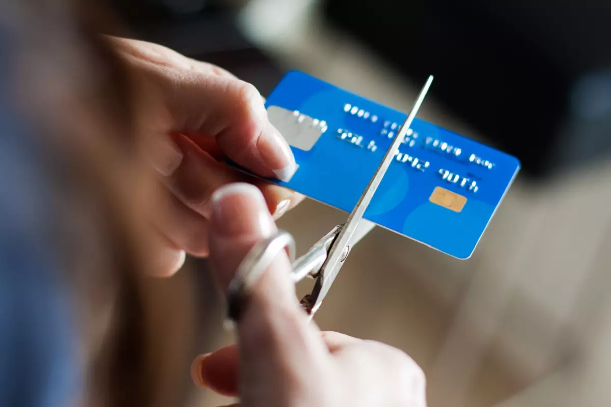 Close up on someone cutting a credit card