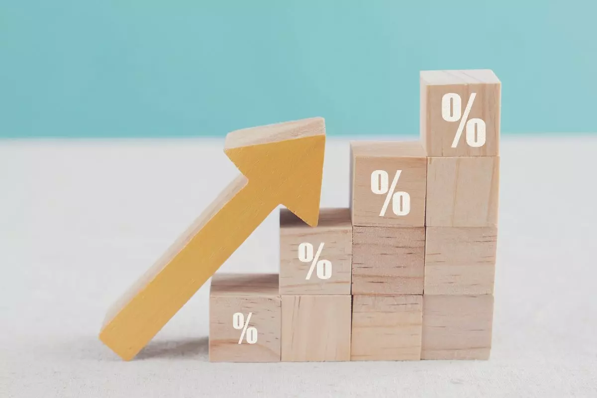 Wooden blocks with inflation percentage sign and arrow pointing up