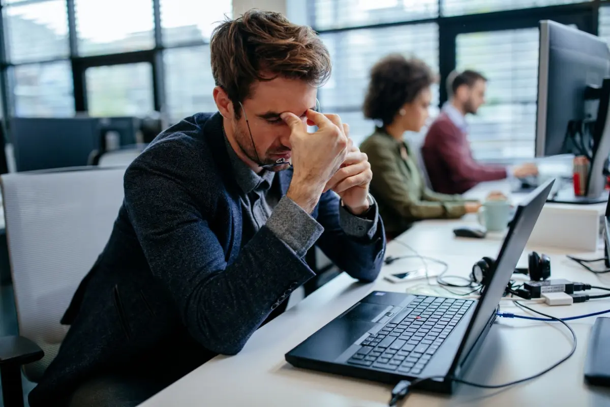 moody man sitting in front of a laptop 