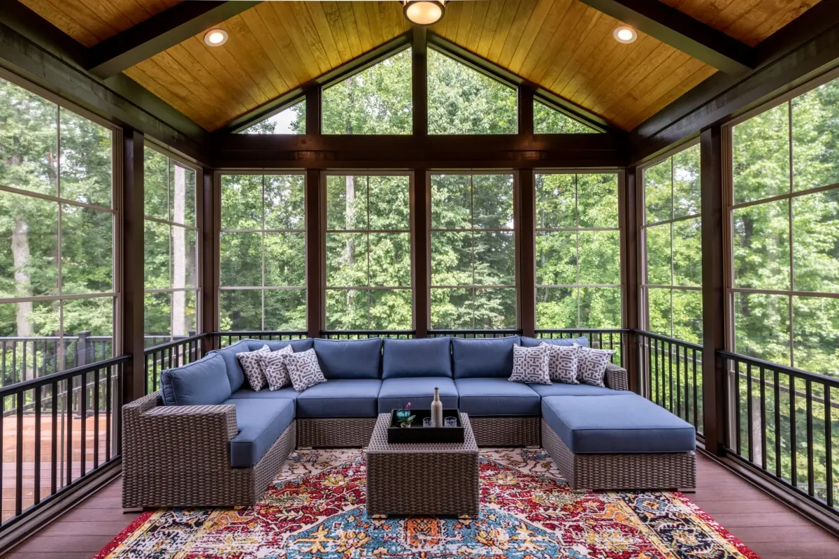 a view of trees through living room large windows of extended house 